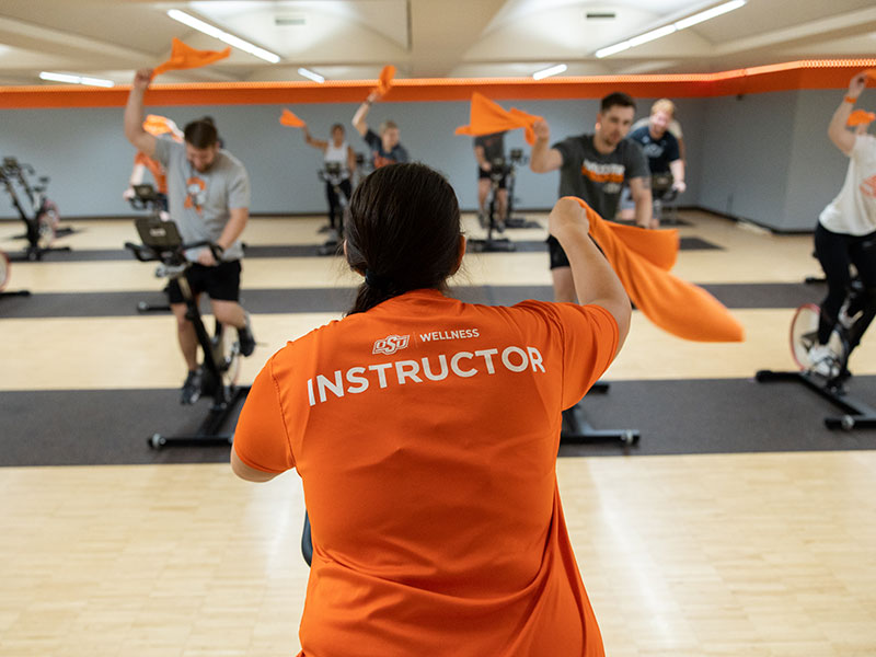Spin instructor leading group fitness class