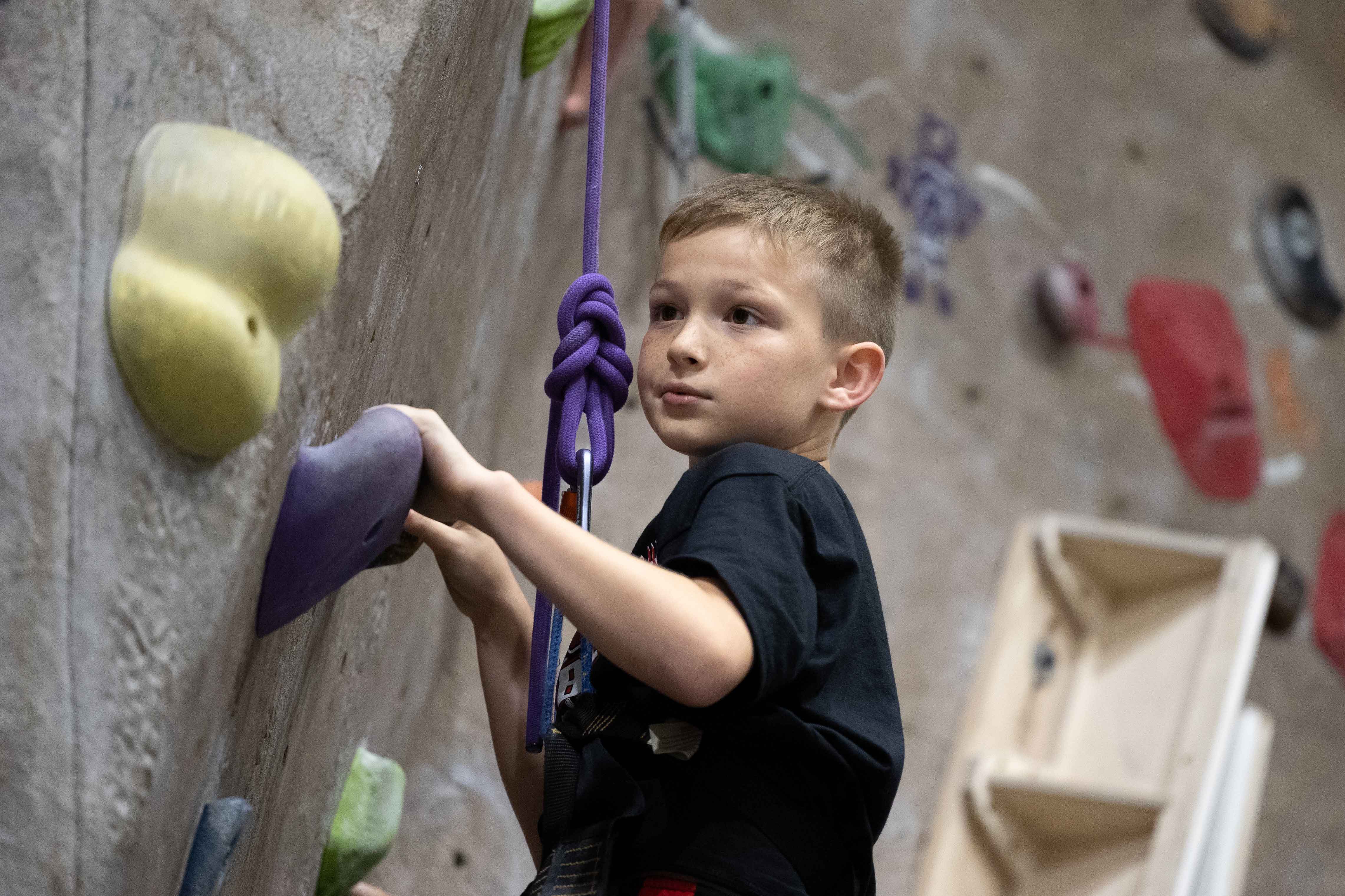 Camper on the indoor climbing wall