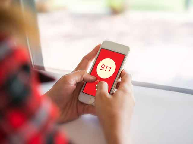 person dialing 911 person dialing 911