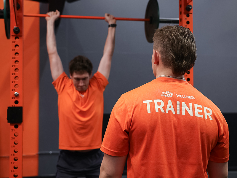 Personal trainer helping client Personal trainer helping client